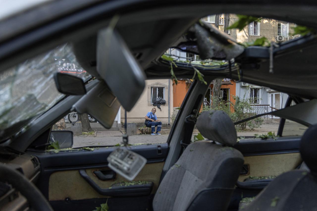 A man sits near a damaged car following a Russian attack in Odesa, Ukraine on July 19, 2025. (AFP Photo)