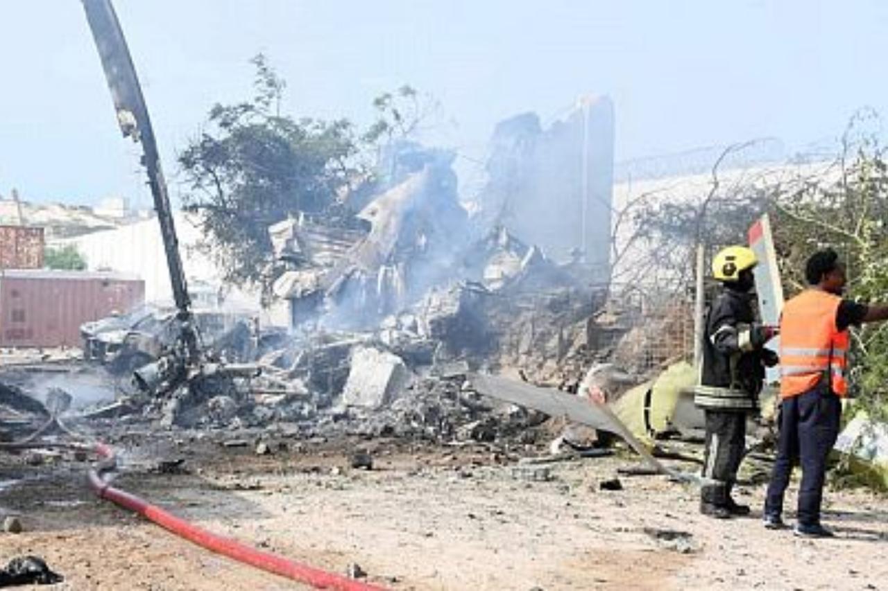Rescue workers inspect the wreckage of a Ugandan army helicopter after it crashed at Mogadishu’s Aden Abdulle International Airport, Somalia, on July 2, 2025. (Photo via X/@recordNewsAF)