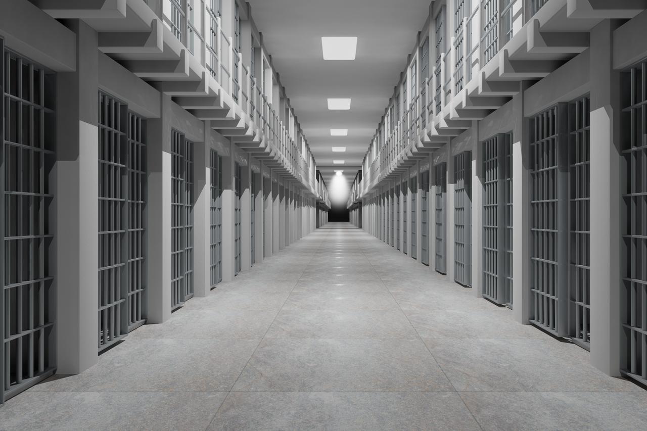 Rows of prison cells line prison interior. (Adobe Stock Photo)