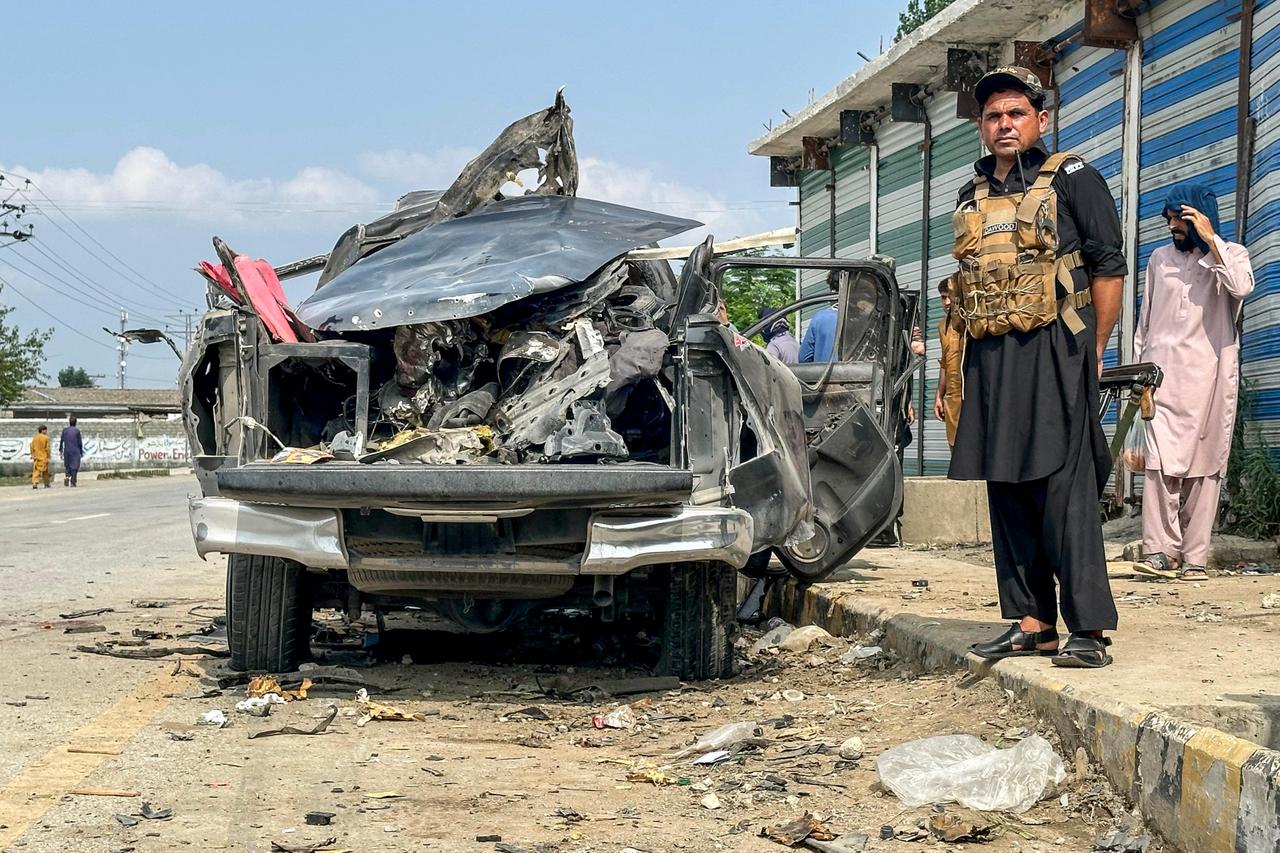 A security personnel stands guard beside the wreckage of a vehicle after a blast in Bajaur, Khyber Pakhtunkhwa province, on July 2, 2025. (AFP Photo)