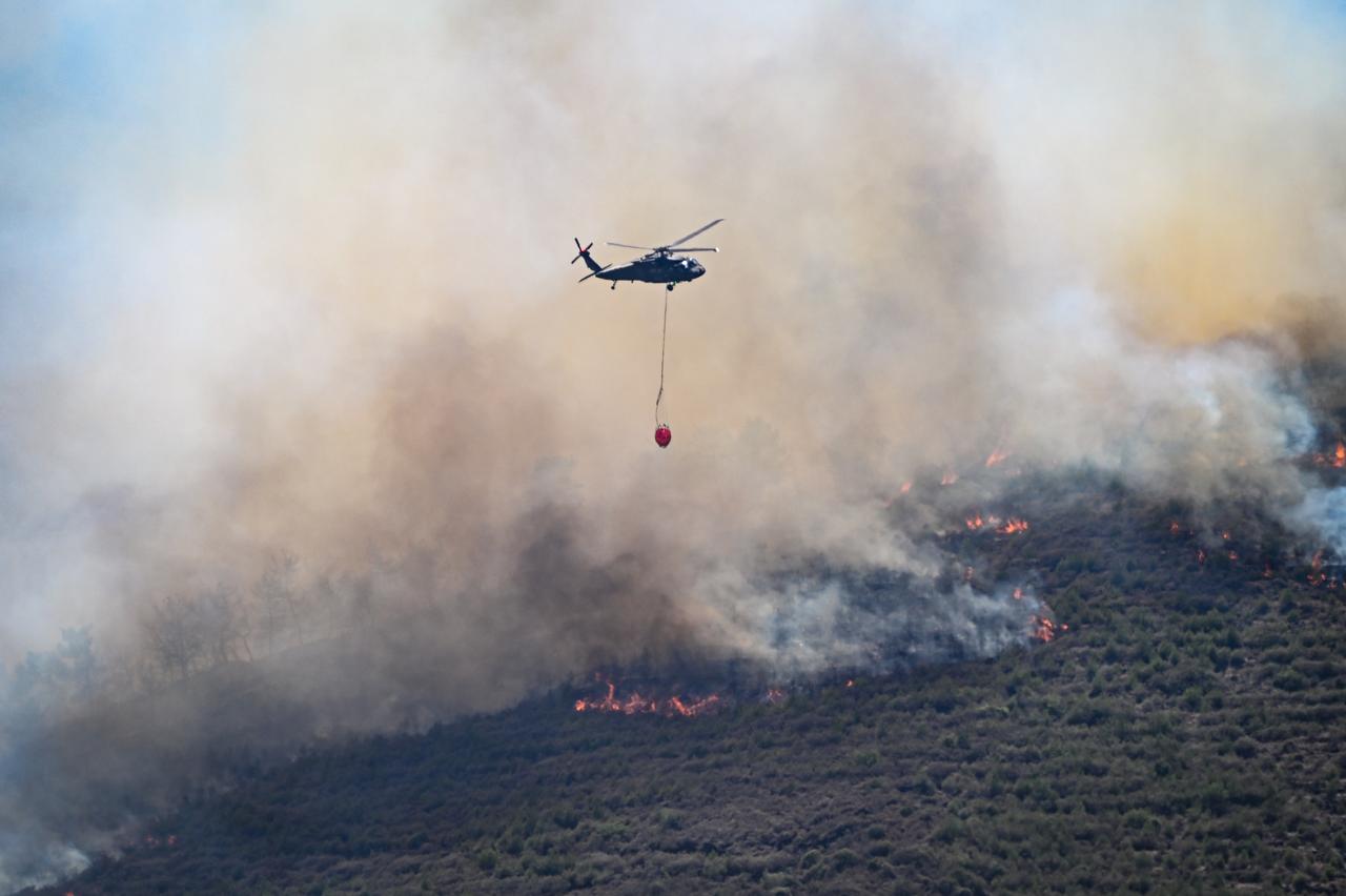 Firefighting helicopters, water cannons contributed to firefighting efforts as security personnel and residents helped firefighting teams battling wildfires that broke out in Antakya district of Hatay, Türkiye on July 1, 2025. (AA Photo)