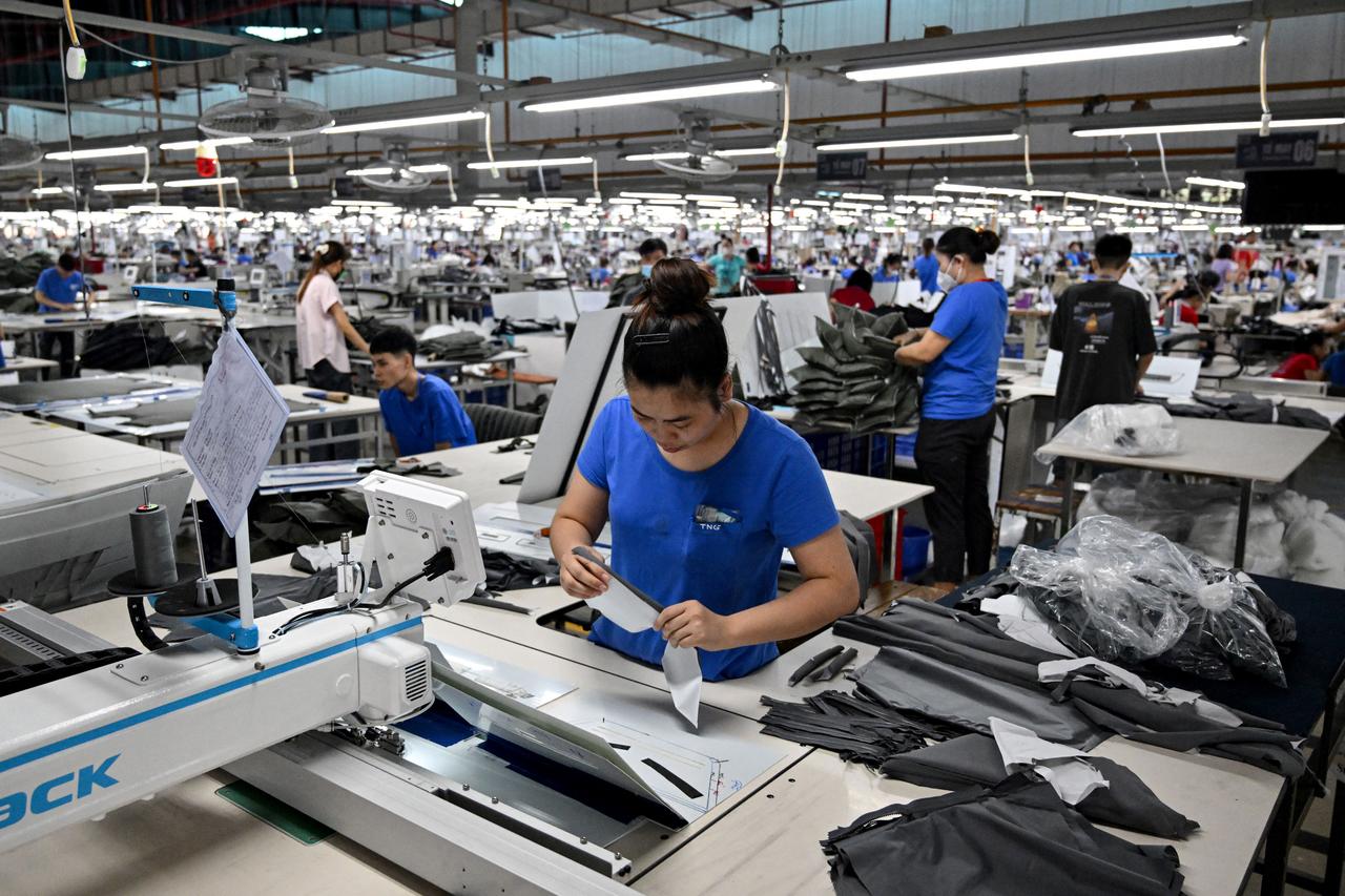 Workers stitch apparels at a garment factory in Vietnam's Thai Nguyen Province on July 2, 2025. Vietnam, a global manufacturing hub dependent on exports, faces a potential "reciprocal tariff" hike from 10 to 46 percent without a US trade deal. (AFP Photo)