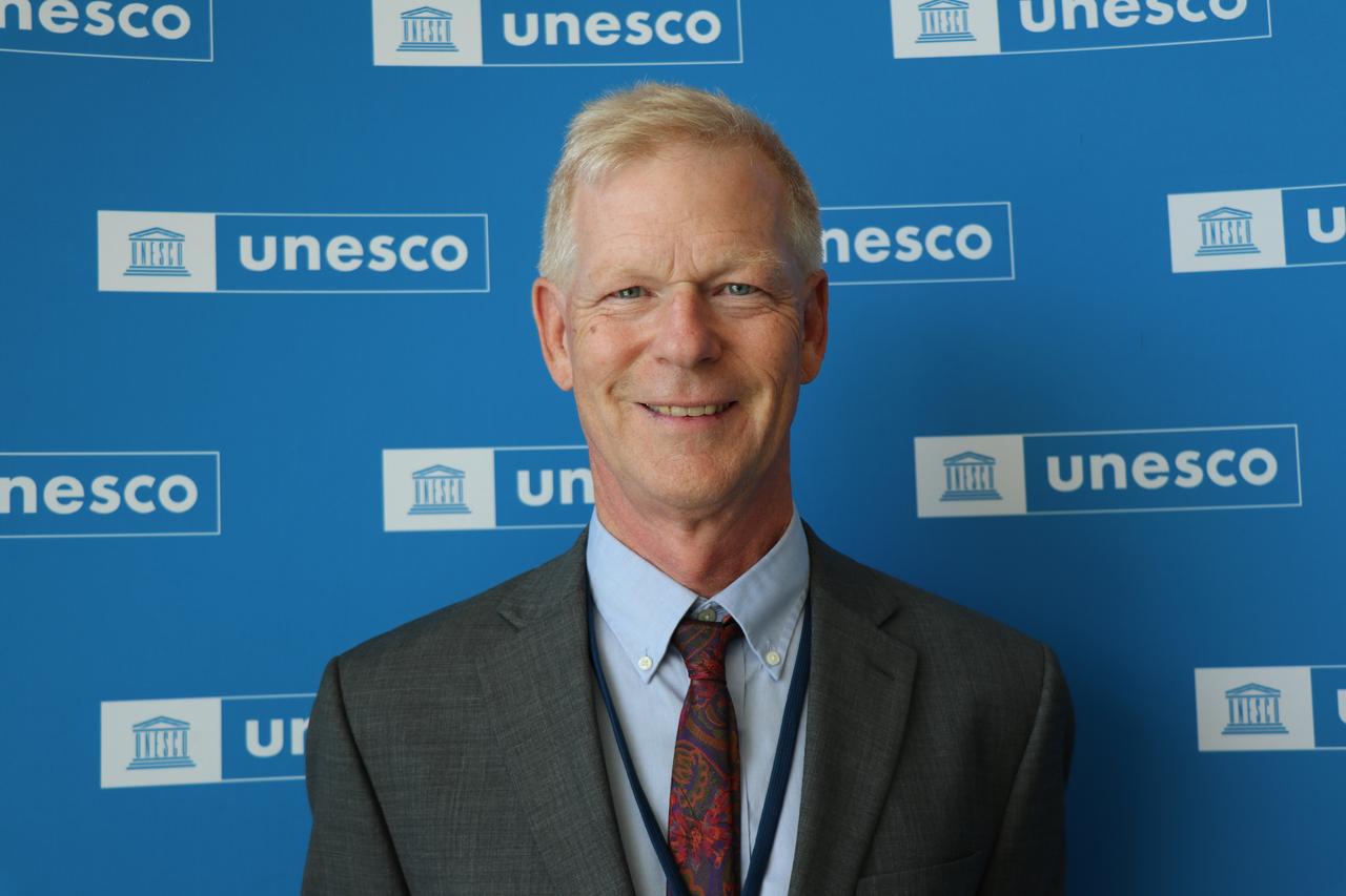 Professor Nicholas Cahill, head of the Sardis excavation team, stands before the UNESCO backdrop following the site’s recognition, Paris, France, July 12, 2025. (AA Photo)