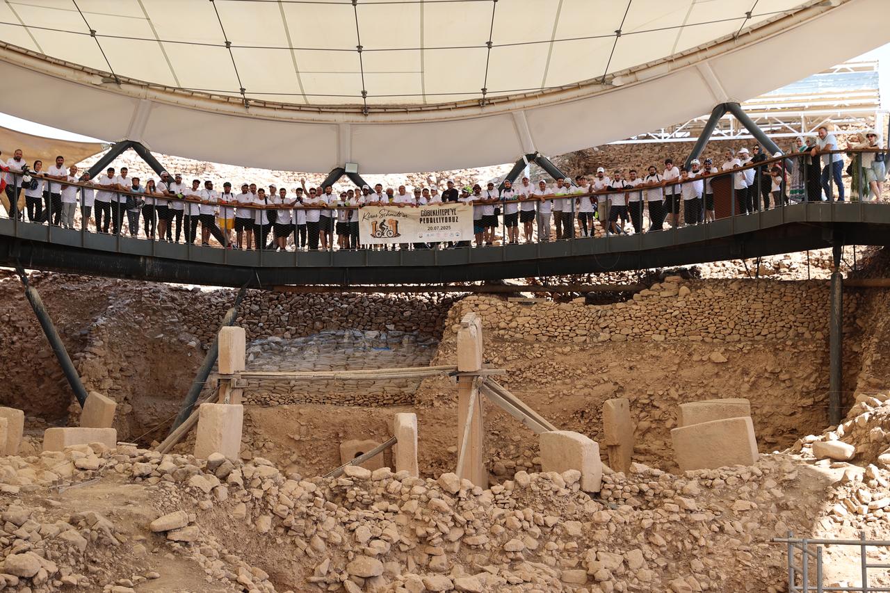A group of 150 cyclists rode 20 km to visit Gobeklitepe as part of a memorial event for Prof. Klaus Schmidt, who uncovered the UNESCO-listed site, Sanliurfa, July 20, 2025. (AA Photo)