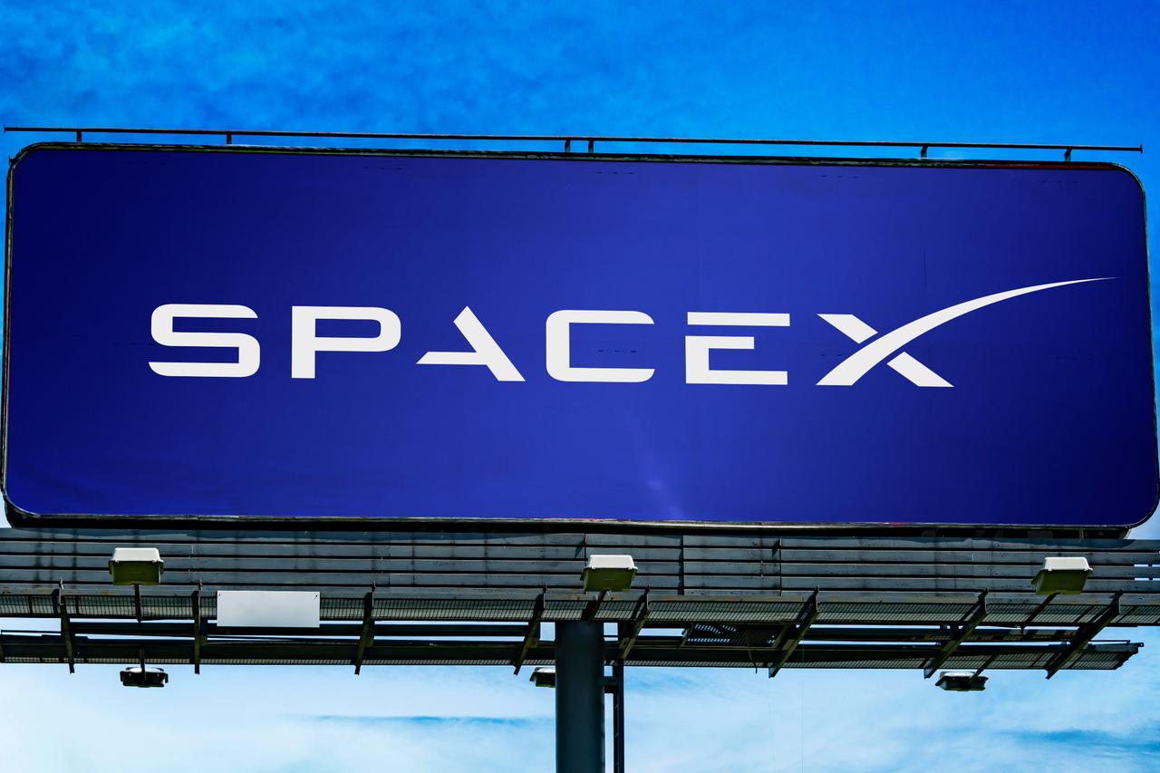 Advertisement billboard displaying logo of SpaceX, an American space technology company (Adobe Stock Photo)
