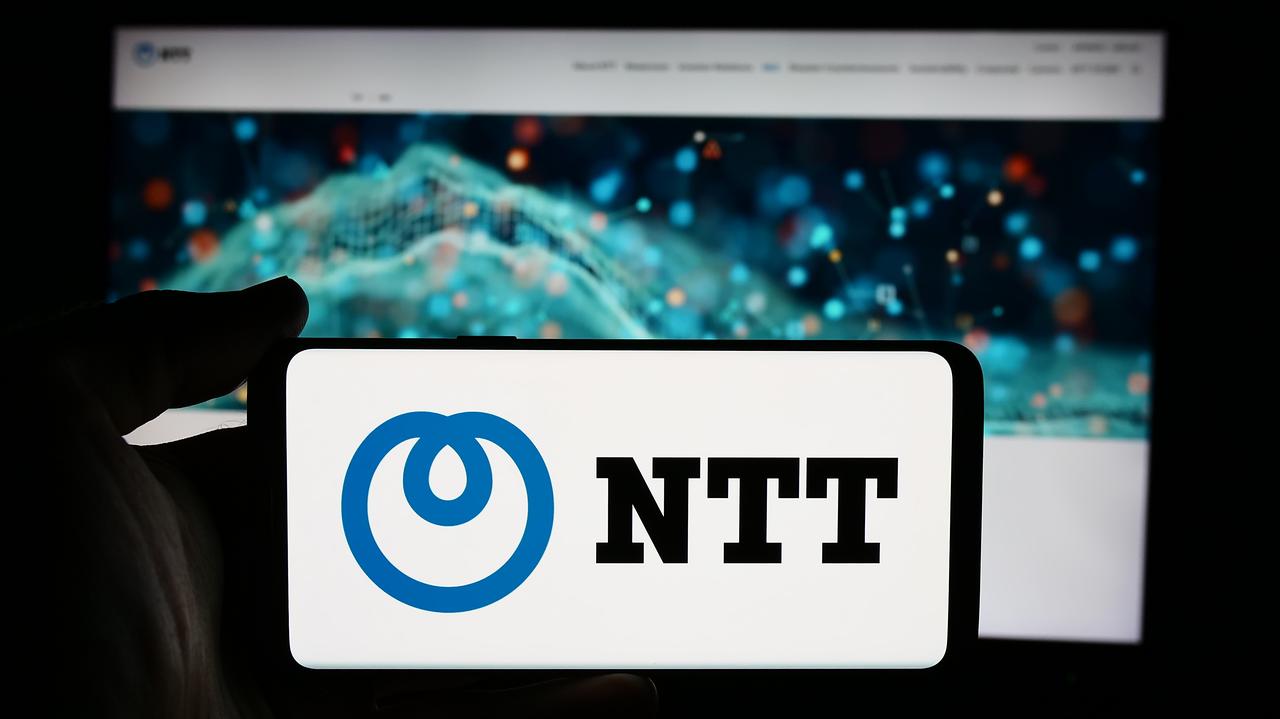 A smartphone displays the logo of NTT Group, the parent company of Transatel. (Adobe Stock Photo)