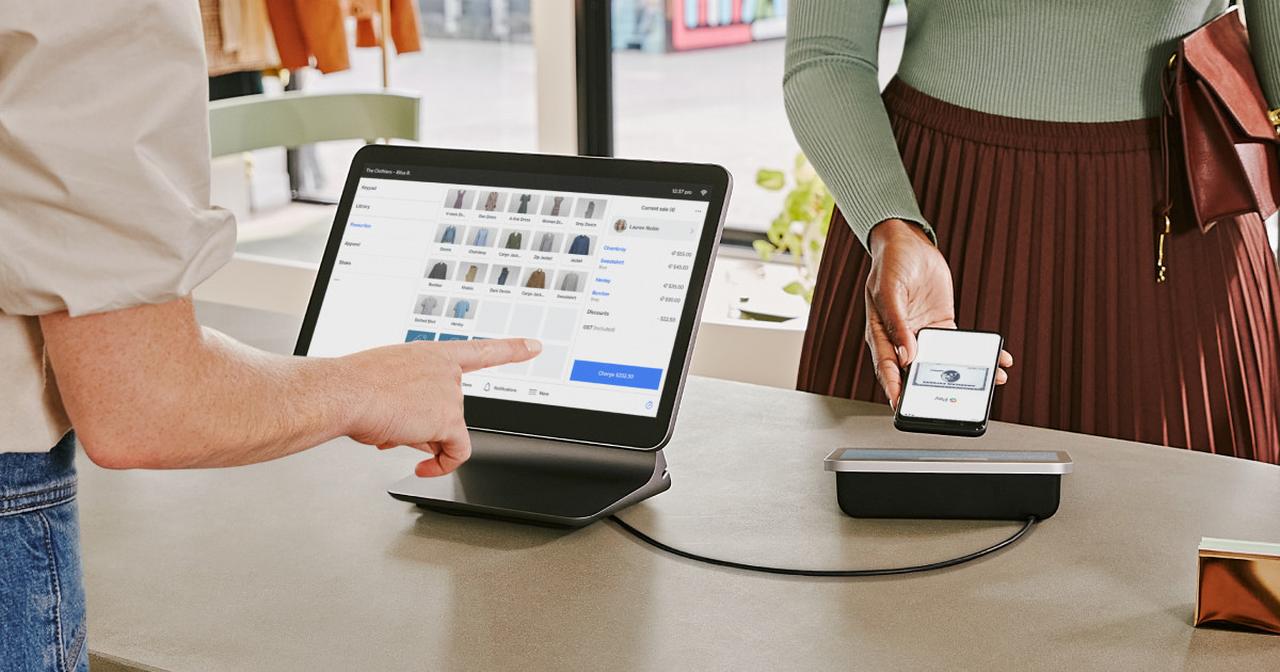 Promotional photo shows a customer making a contactless payment using a mobile device on Square’s point-of-sale system at a retail store. (Photo via squareup.com)