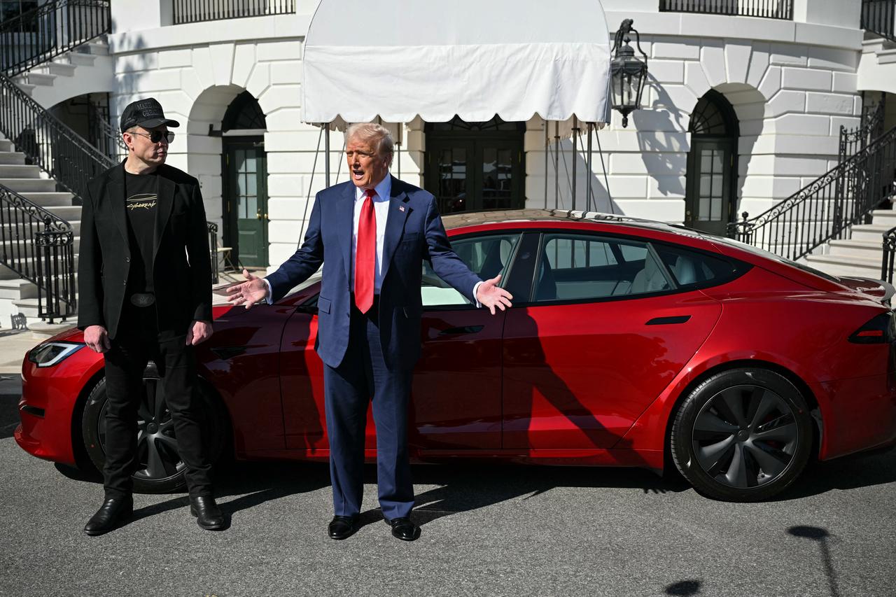US President Donald Trump and Tesla CEO Elon Musk speak to the press as they stand next to a Tesla vehicle on the South Portico of the White House in Washington, DC, March 11, 2025. (AFP Photo)