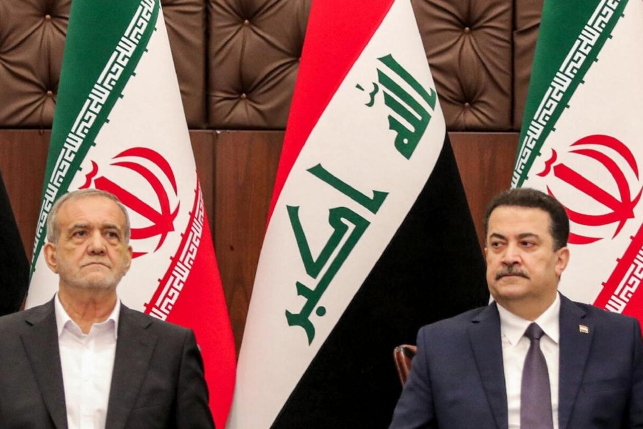 Iraqi Prime Minister Mohammed Shia al-Sudani (R) and Iranian President Masoud Pezeshkian attend a ceremony for the signing of memoranda of understanding in Baghdad (AFP Photo)
