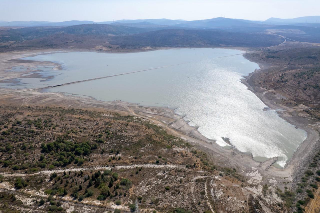 Aerial view of the Alacati Kutlu Aktas Dam shows dramatically receded water levels, with vast expanses of exposed lakebed visible around the remaining water in Izmir, Türkiye, accessed on July 25, 2025. (Photo via IZSU)