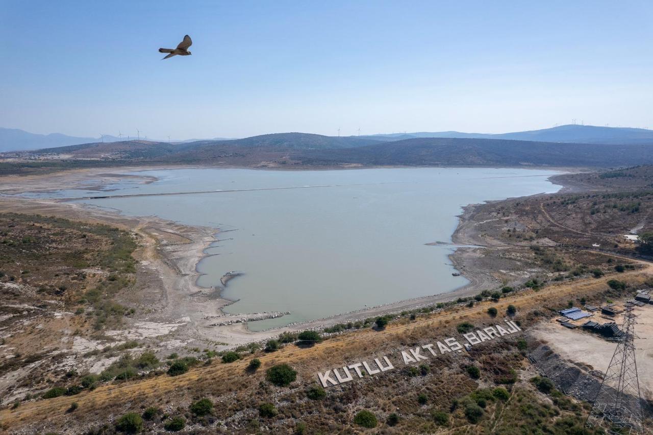 The Kutlu Aktas Baraji sign stands near the severely depleted Alacati Kutlu Aktas Dam, where water levels have fallen to critical levels in İzmir, Türkiye, accessed on July 25, 2025. (Photo via IZSU)