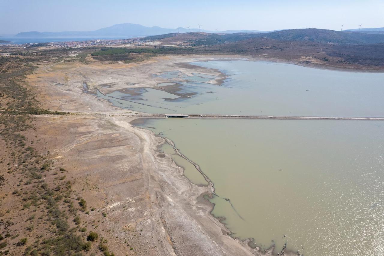 The Alacati Kutlu Aktas Dam's stark transformation is evident in this aerial photograph, showing extensive dried sections where water once filled the reservoir in İzmir, Türkiye, accessed on July 25, 2025. (Photo via IZSU)