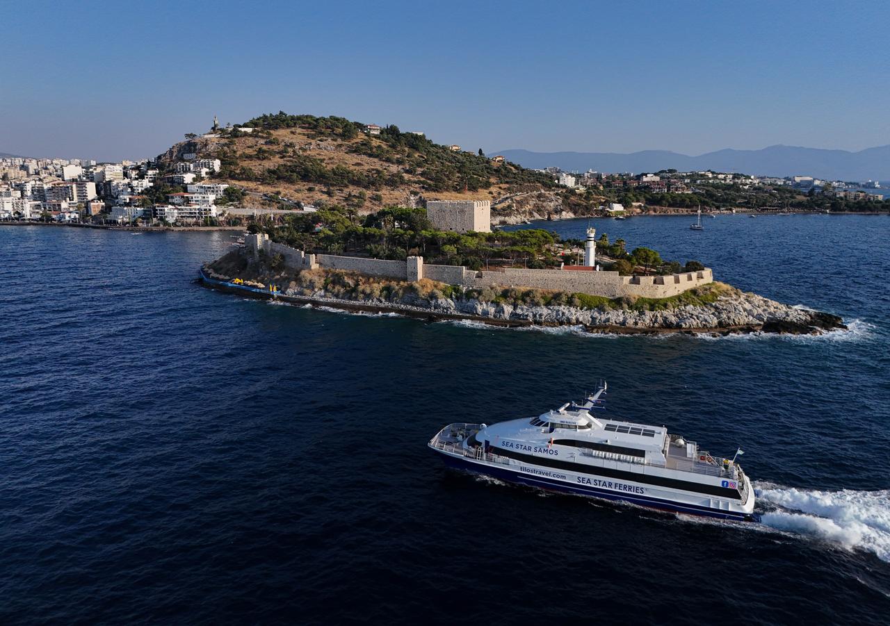 An aerial view of historical Guvercinada (Pigeon Island) Castle, located near the harbor with the ships docking at the port in Kusadasi, Aydin, Türkiye, July 19, 2025. (AA Photo)