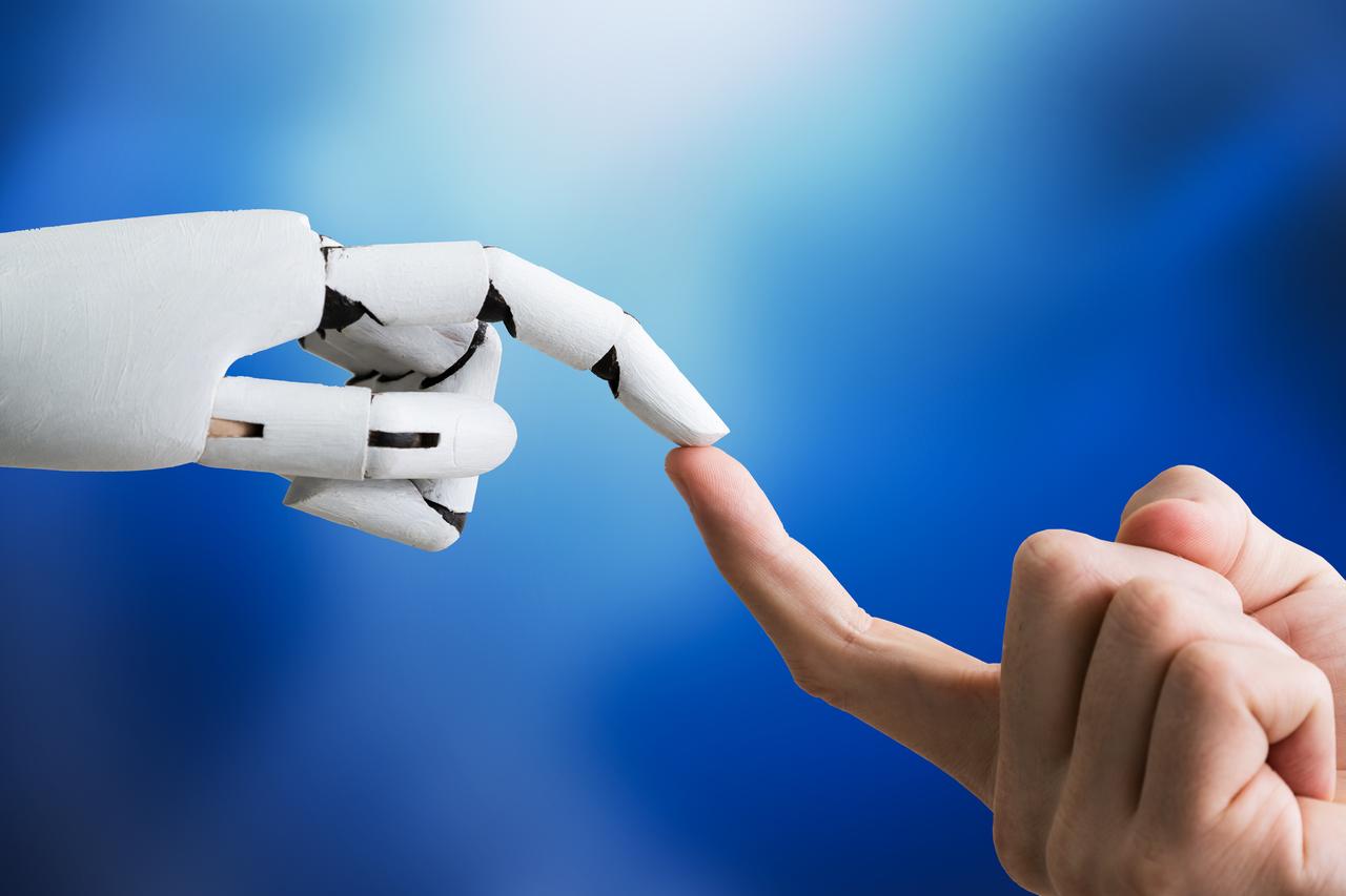 A dynamic exchange between a human and artificial intelligence, showcasing the evolving relationship between people and advanced AI systems in communication, problem-solving, and decision-making. (Adobe Stock Photo)