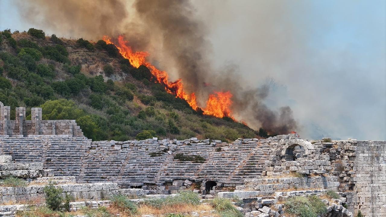 Flames are seen around the theater structure of the ancient city of Perge in Antalya, Türkiye, in a post shared on X by Isa Yildirim, Mayor of Aksu District, July 25, 2025. (Photo via X/@aksuisayildirim)
