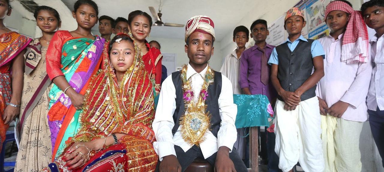 A child bride and groom sit for a wedding ceremony in rural South Asia. (Photo via UNICEF)