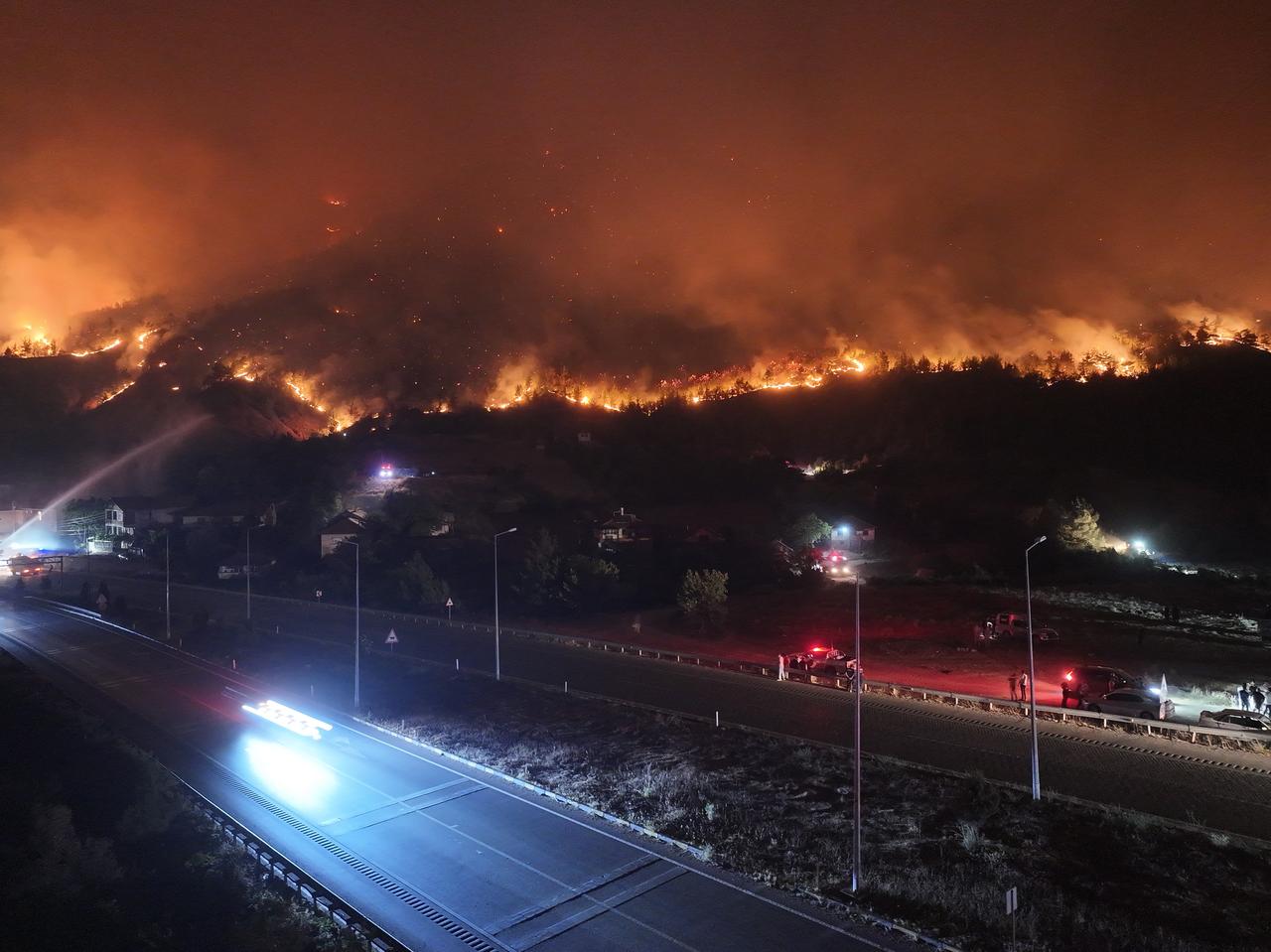 An aerial view shows flames engulfing a forested hillside as firefighters battle a wildfire for the fourth day in Safranbolu district of Karabuk, Türkiye, July 26, 2025. (AA Photo)