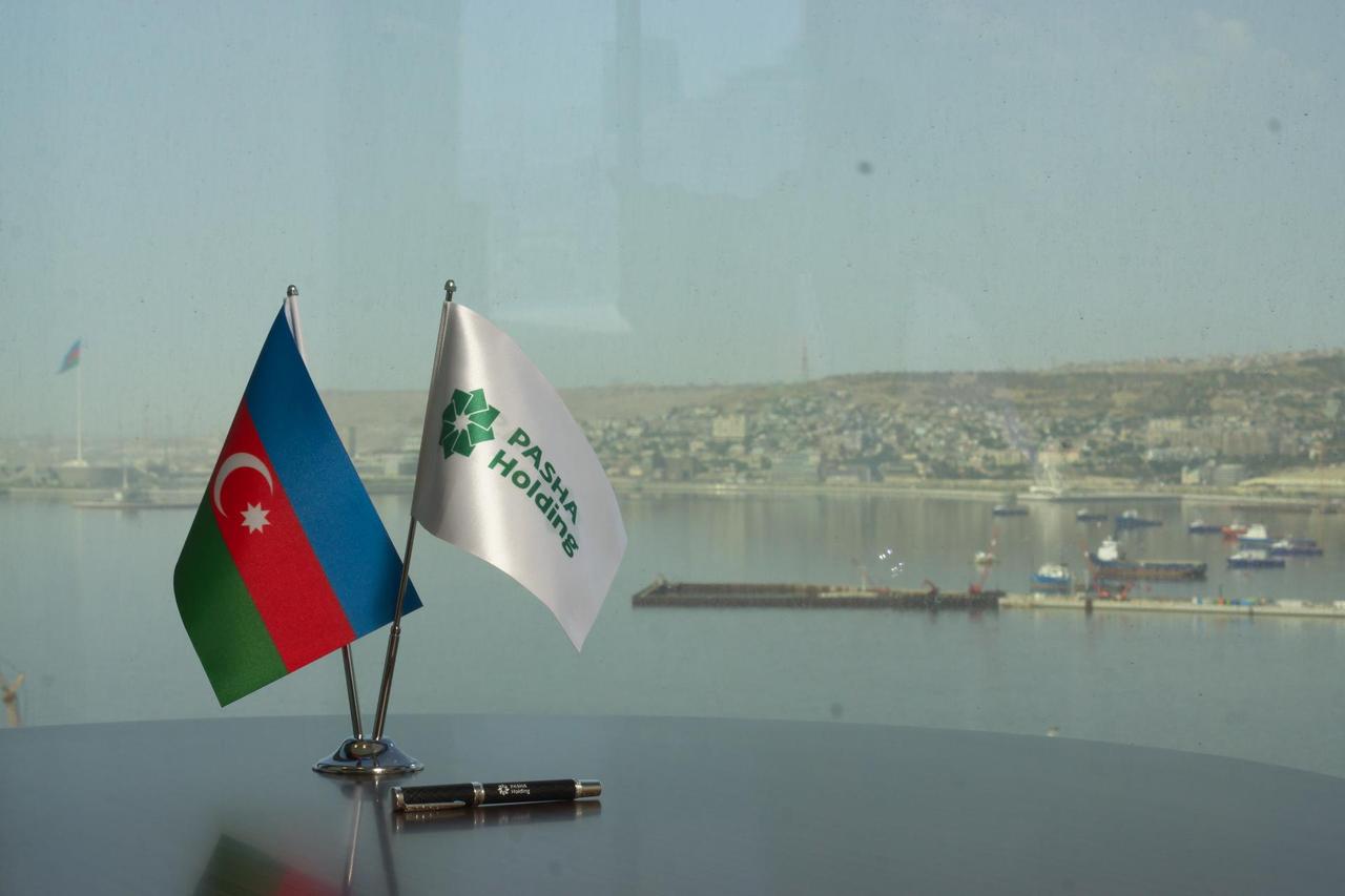 The national flag of Azerbaijan and the corporate flag of Pasha Holding displayed at the company’s headquarters in Baku, Azerbaijan. (Photo via facebook.com/PashaHoldingLLC)