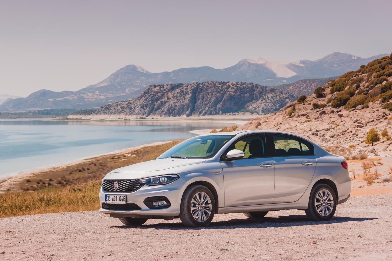 A Fiat Egea parked on a gravel road near Lake Salda in Burdur, Türkiye, September 7, 2020. (Adobe Stock Photo)