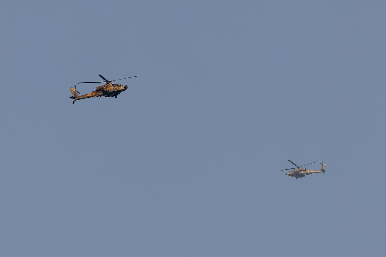 This picture taken from a position at Israel's border with the Gaza Strip shows two Israeli Apache helicopters above the besieged Palestinian territory on July 1, 2025. (AFP Photo)