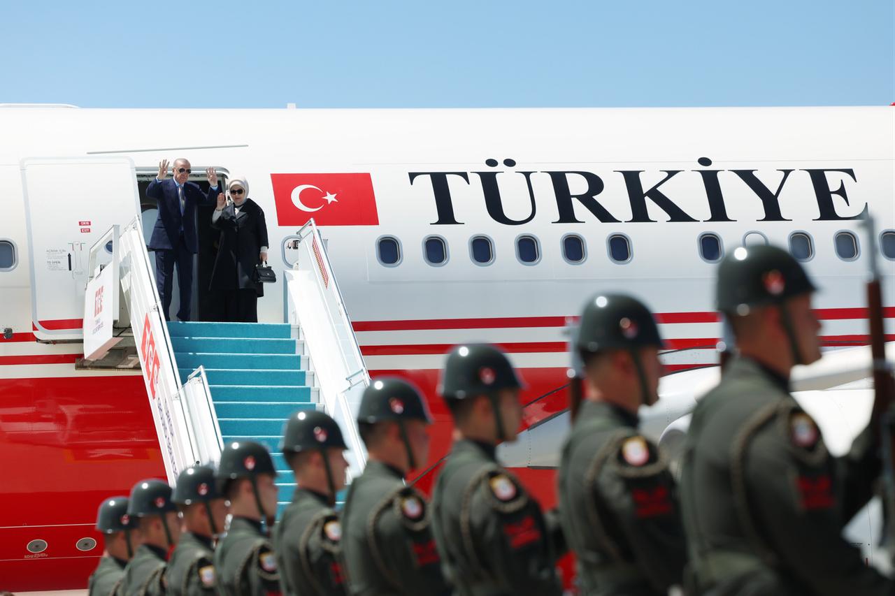 President Recep Tayyip Erdogan and First Lady Emine Erdogan greet officials at Esenboga Airport in Ankara, Türkiye, on June 24, 2025. (Turkish Presidency / Murat Kula - Anadolu Agency)