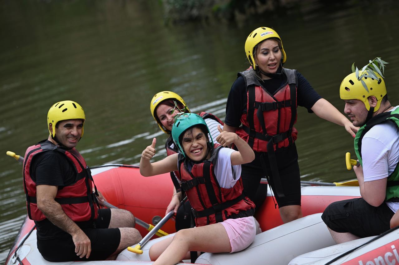 People with special needs take part in rafting tours as part of “Happiness Boat" project organized on certain days of the year by rafting companies in Duzce, Türkiye, July 1, 2025. (AA Photo)