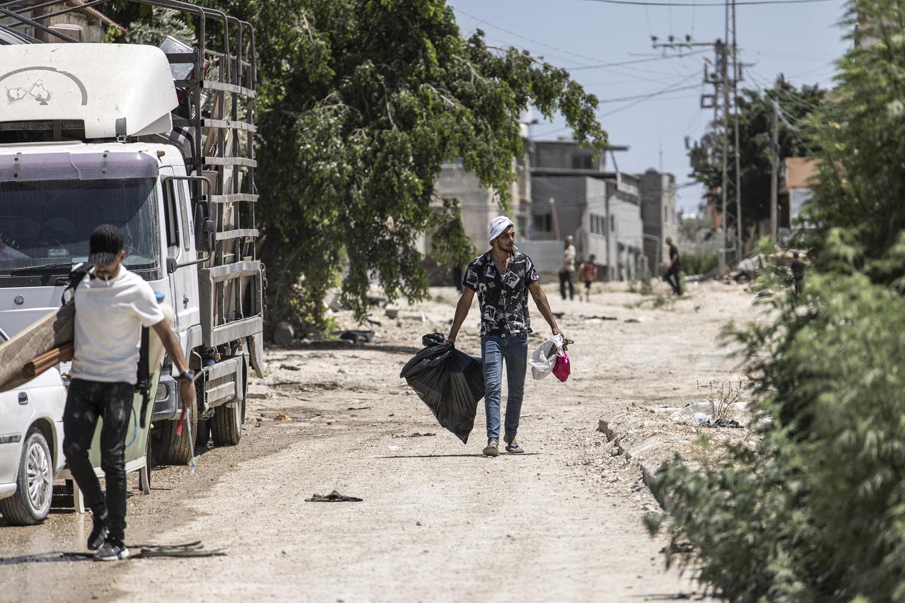 People carry their belongings as they clear their home in the Tulkarem camp for Palestinian refugees, in the Israeli occupied West Bank, on July 2, 2025. (AFP Photo)