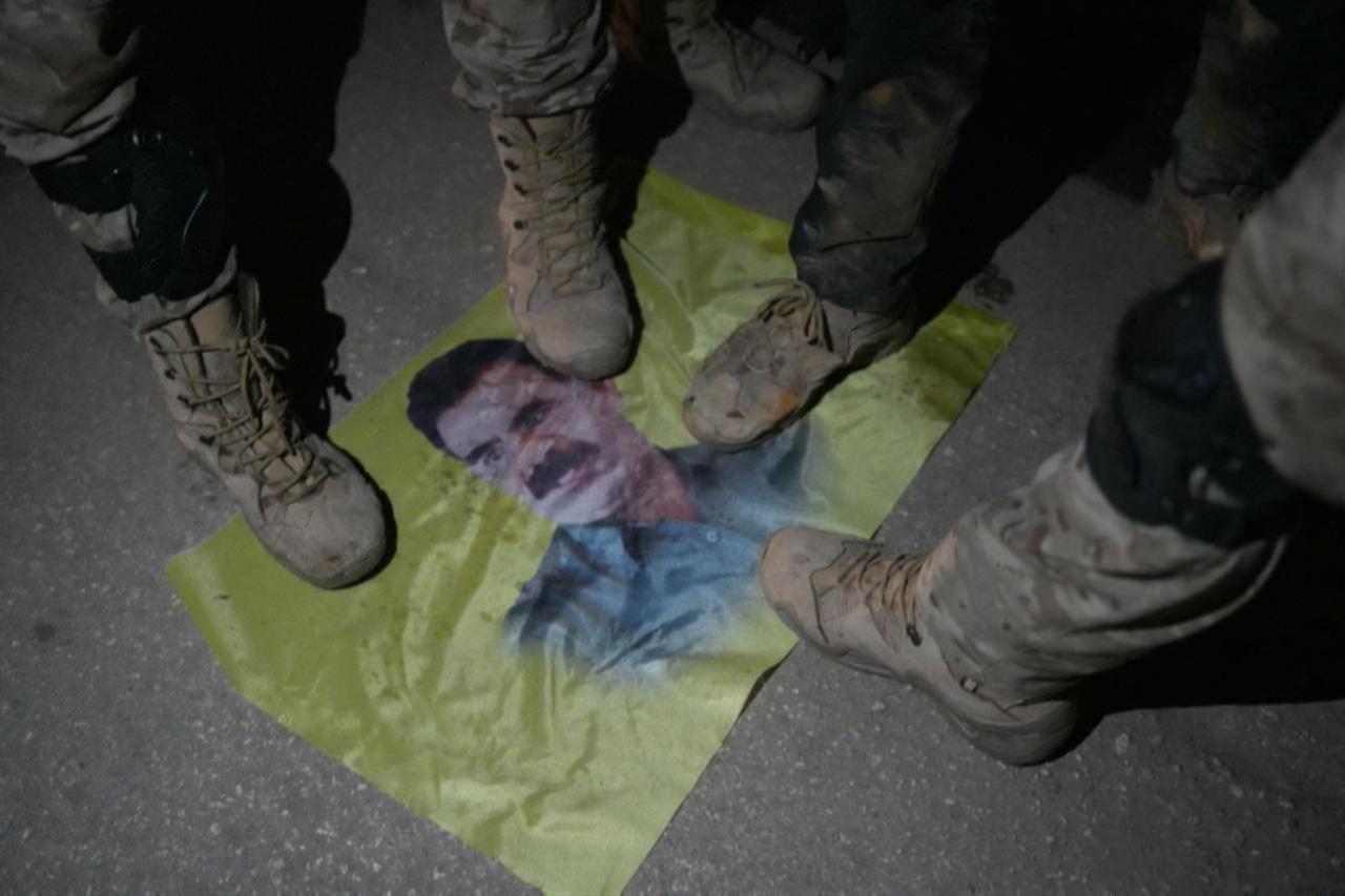 Syrian fighters step on a portrait of PKK/YPG terrorist organization ringleader Abdullah Ocalan as they take over the northern Syrian town of Tal Rifaat on December 1, 2024. (AFP Photo)