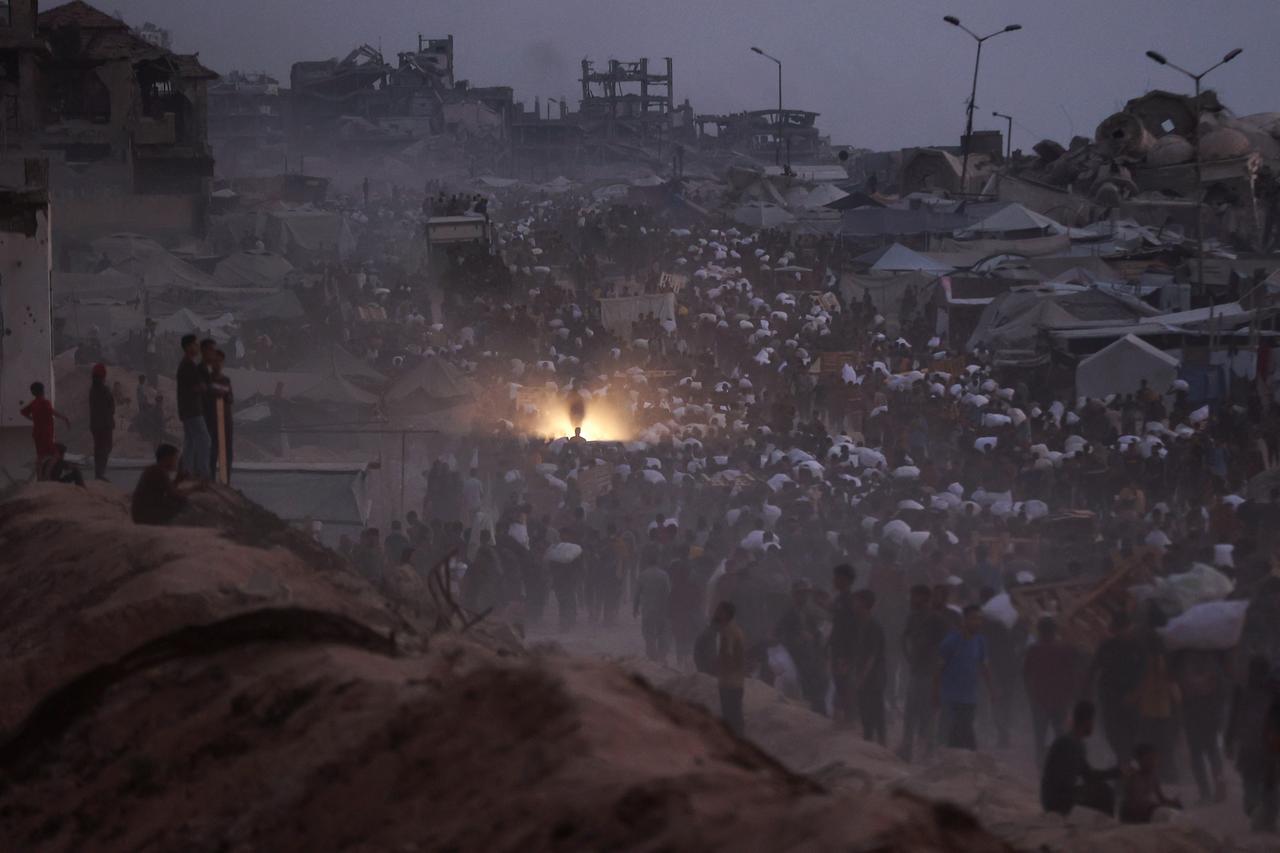 Palestinians bring back aid parcels they managed to procure as they walk on a coastal path west of Beit Lahia on July 29, 2025. (AFP Photo)