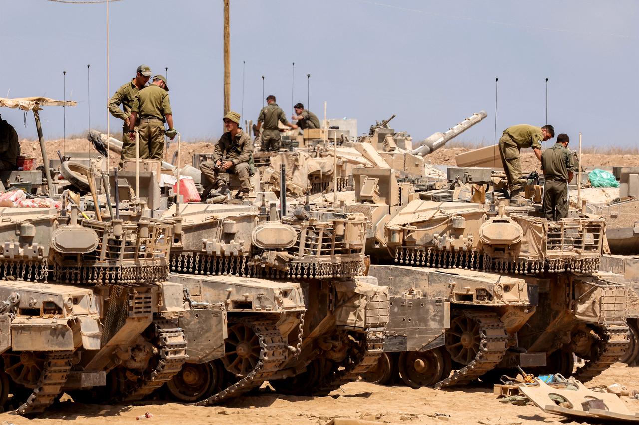 Israeli army soldiers stand atop main battle tanks deployed at a position along the border with the Gaza Strip and southern Israel on July 29, 2025. (AFP Photo)