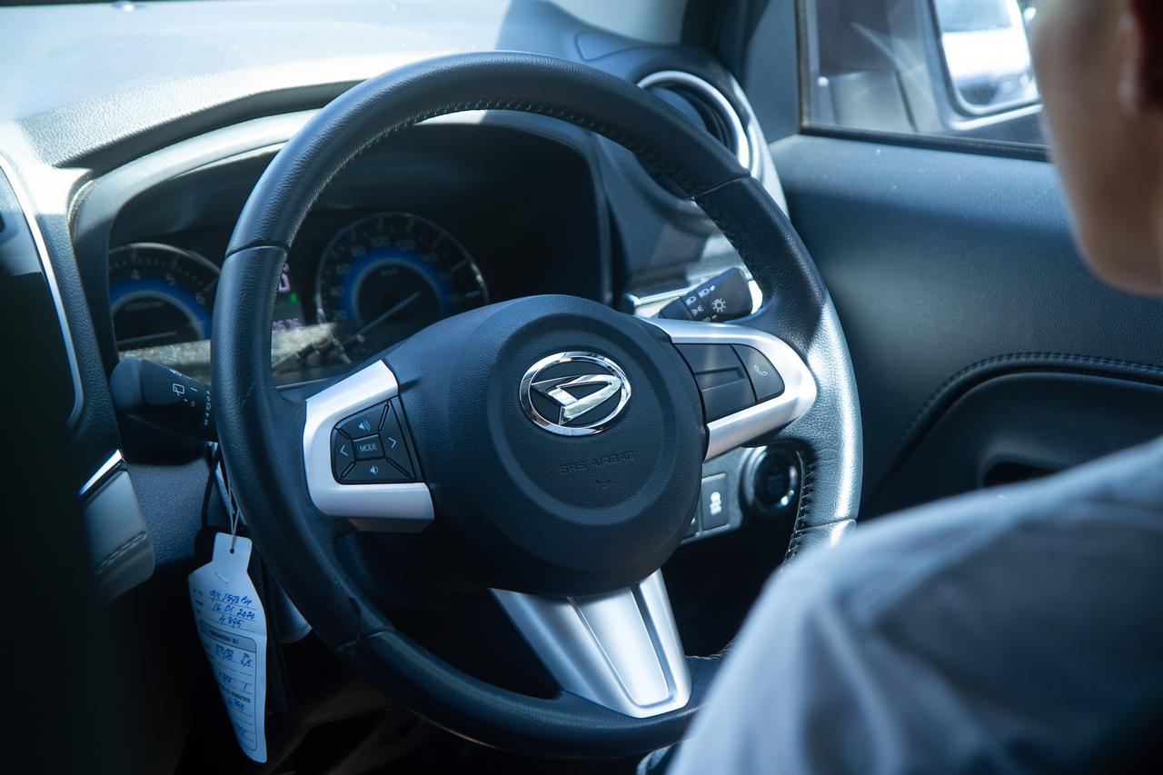 A close-up view of the steering wheel in a Daihatsu vehicle, a subsidiary of Toyota Motor Group. (Adobe Stock Photo)