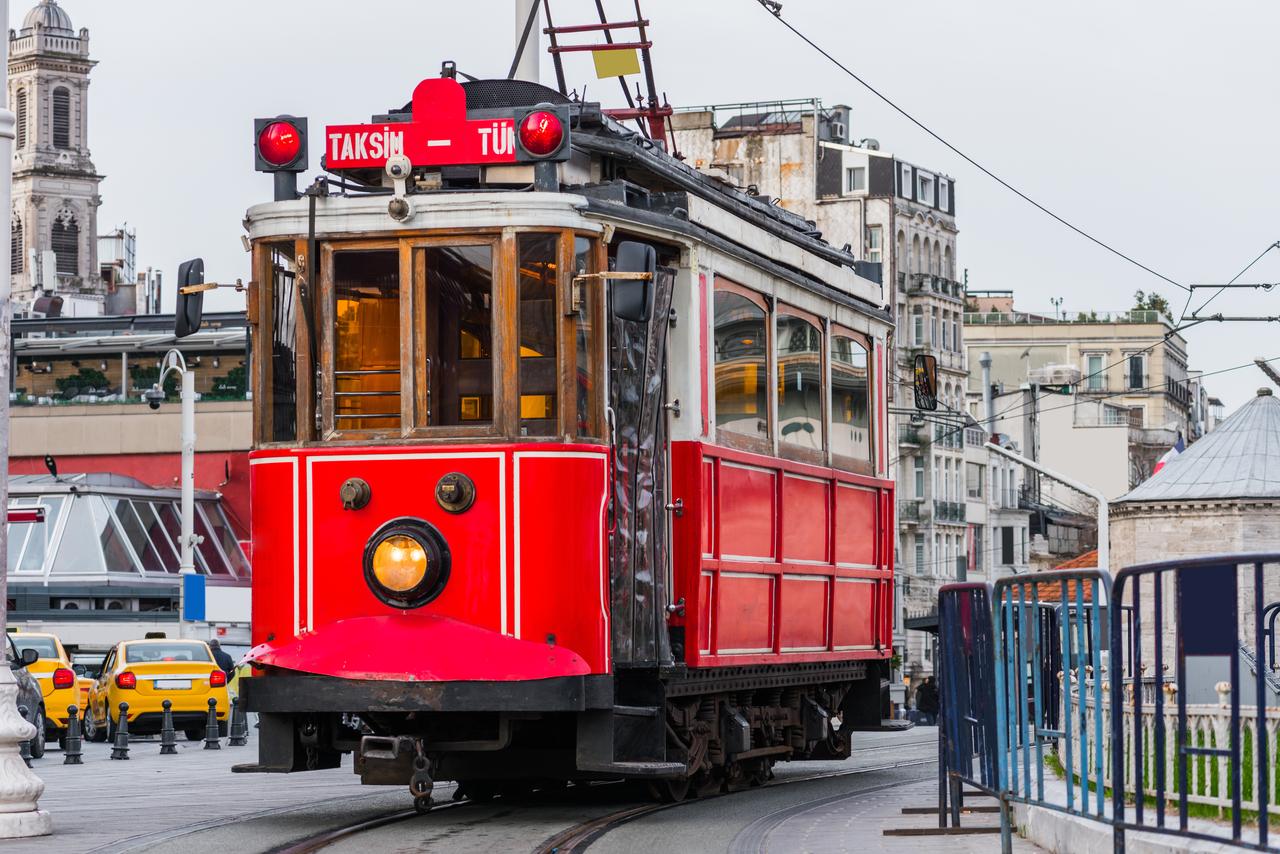 The iconic red tram rolls through historic Istiklal Avenue in the Taksim district in Istanbul, Türkiye, accessed on July 4, 2025. (Adobe Stock Photo)