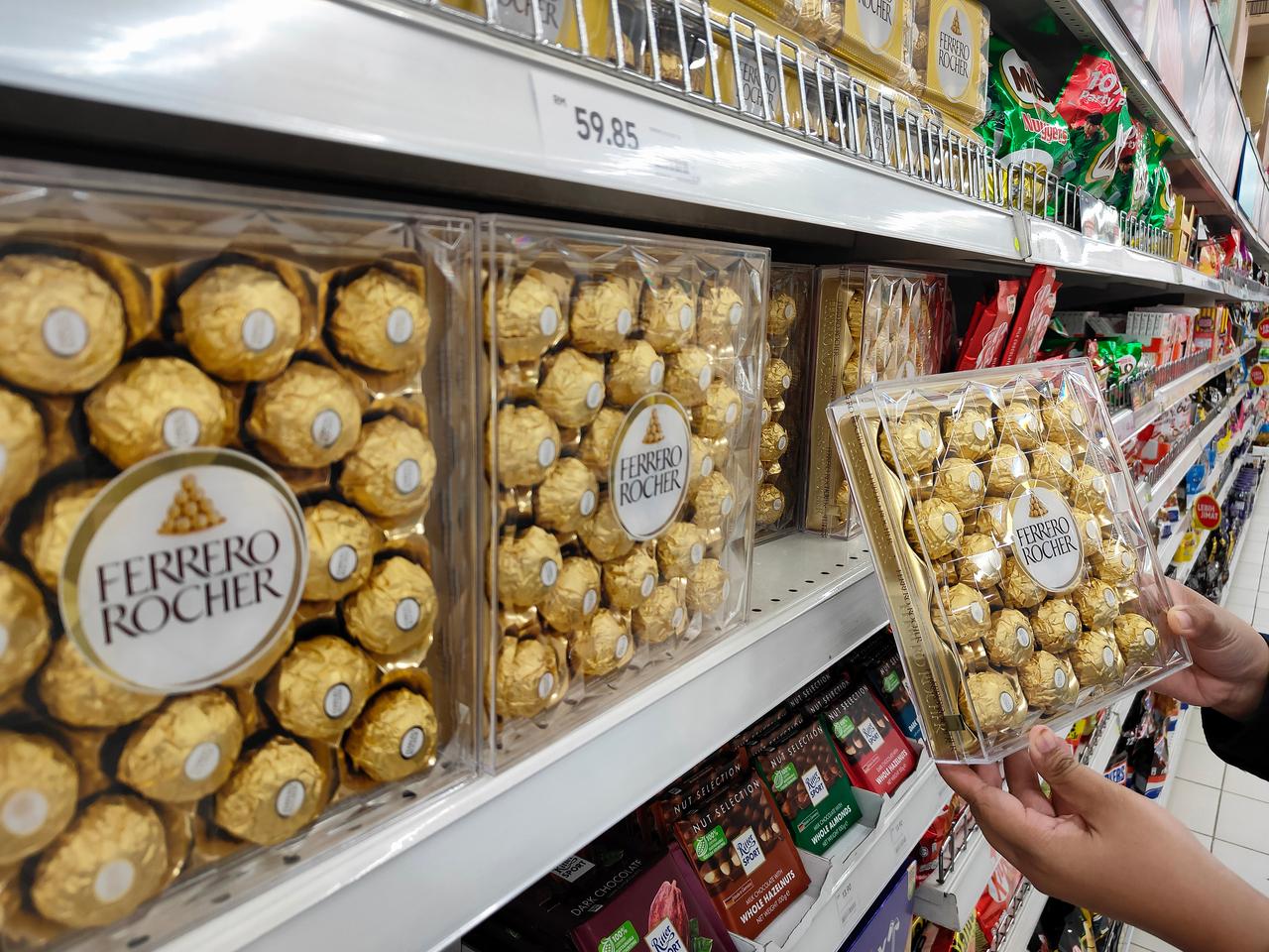 A shopper picks up a box of Ferrero Rocher chocolates from a store shelf in Petaling Jaya, Malaysia, on July 29, 2024. (Adobe Stock Photo)