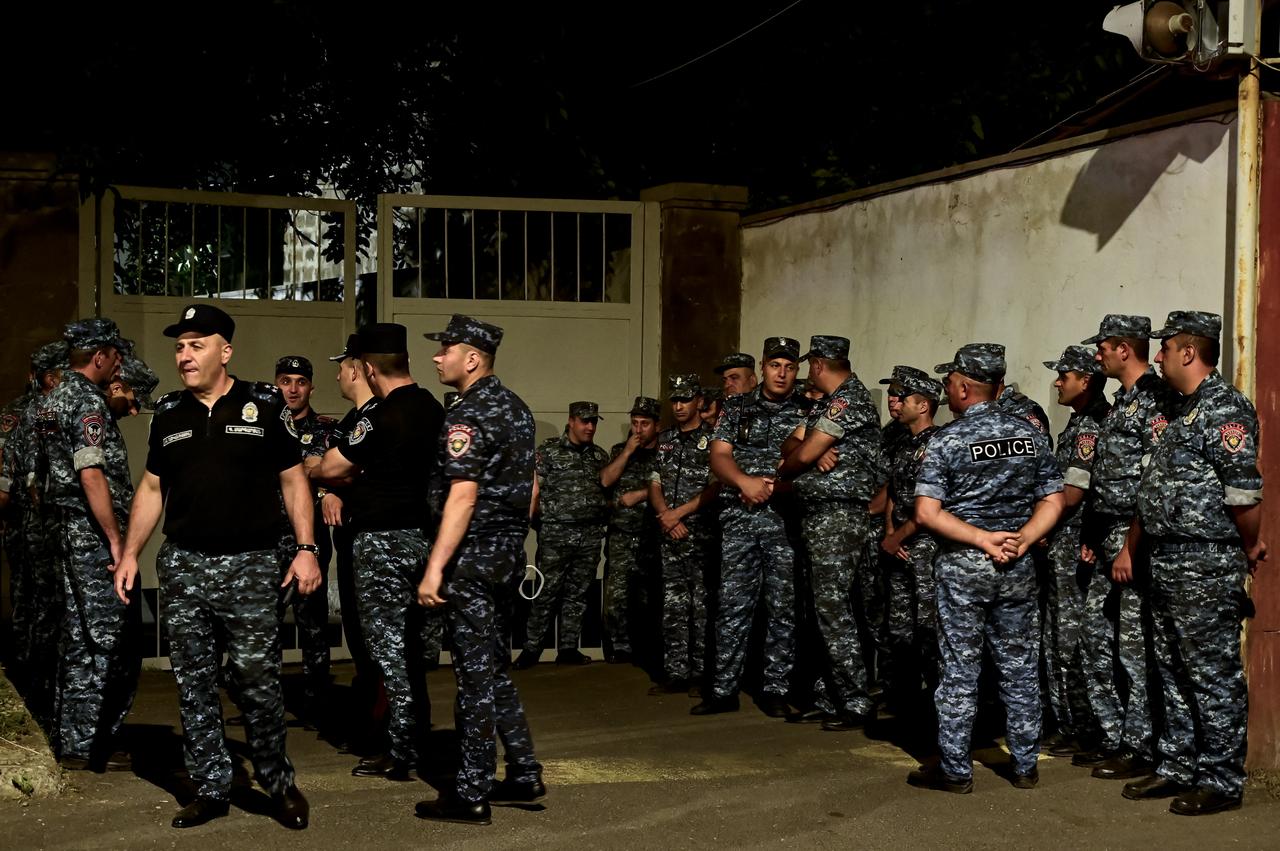 Armenian police officers are seen deployed outside the Avansky court during a rally of supporters of arrested Archbishop of the Armenian Apostolic Church Bagrat Galstanyan, accused of trying to mastermind the attempted coup, in Yerevan on June 25, 2025. (AFP Photo)