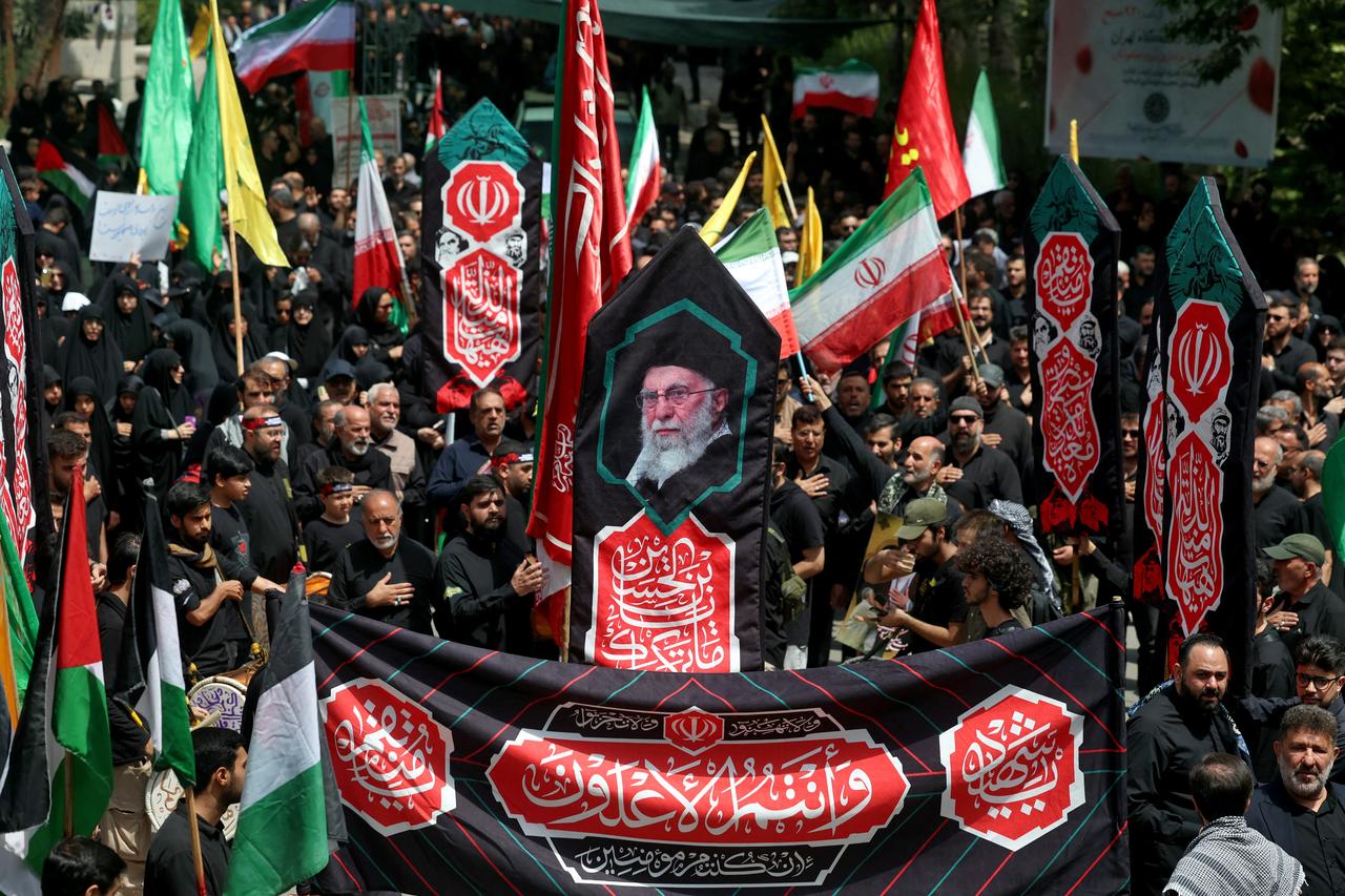 Iranians carry a banner bearing the images of supreme leader Ali Khamenei during a rally in his support, as Shiite Muslims attend the "Tasua" (ninth day) mourning ritual to commemorate martyrdom of Prophet Mohammad's grandson Imam Hussein, during the Islamic month of Muharram ahead of Ashura on July 5, 2025. (AFP Photo)
