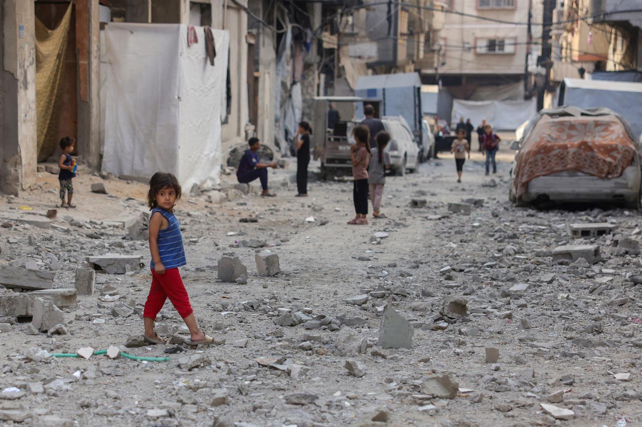 Palestinian children stand on a street covered in the rubble of a building targeted in an Israeli strike in the Sheikh Radwan neighbourhood in Gaza City, in the central Gaza Strip on July 6, 2025. (AFP Photo)