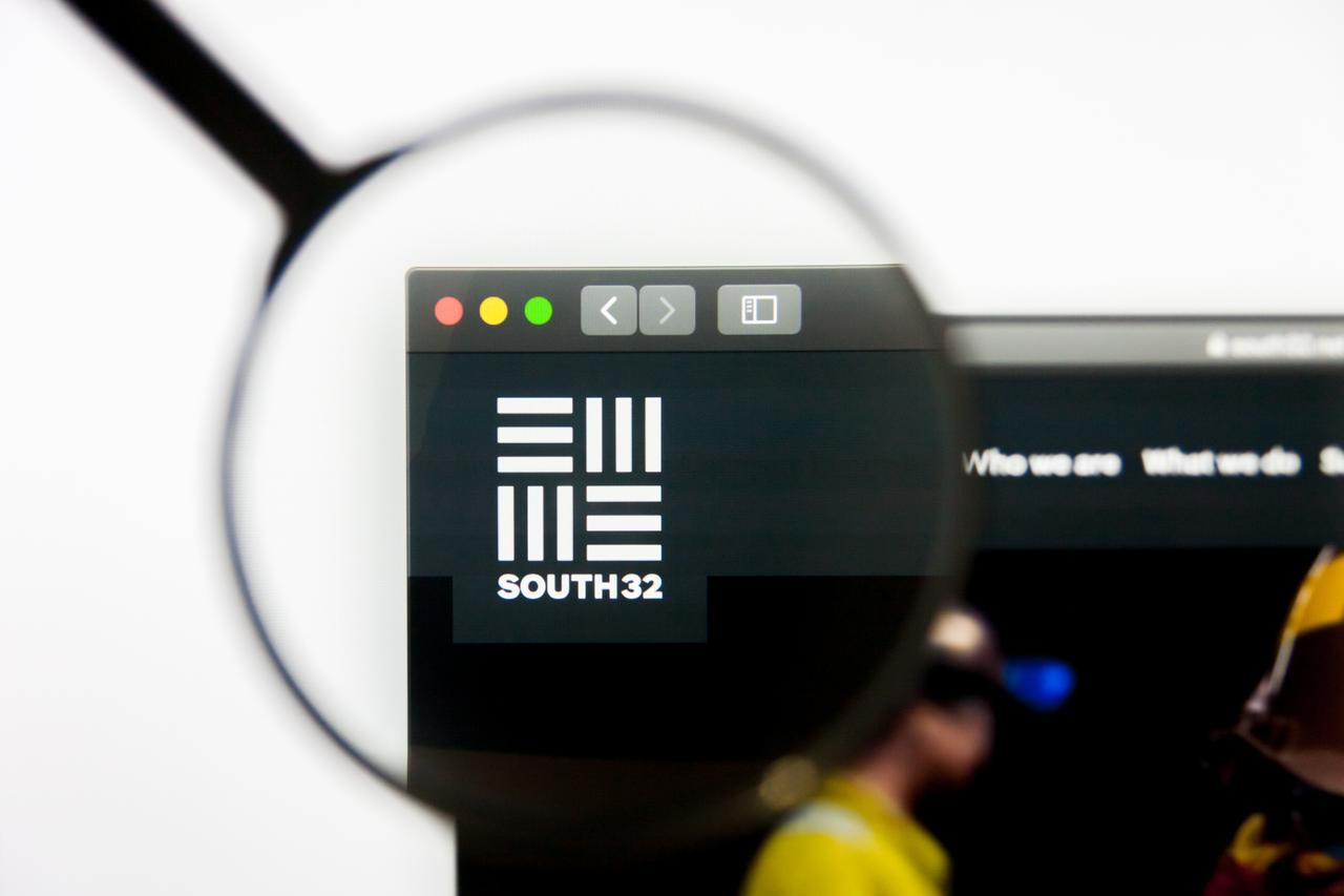 Photo illustration shows the South32 logo displayed on the company’s website, viewed through a magnifying glass, in Los Angeles, California, on March 10, 2019. (Adobe Stock Photo)