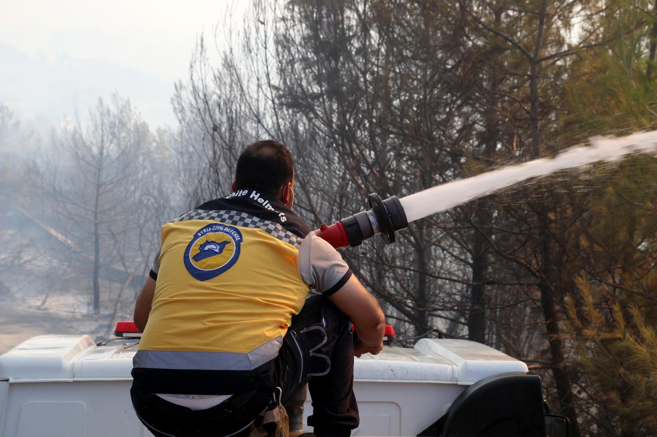 Smoke and flame rises from the area as firefighters continue to extinguish fires broke out in the forest area, İn Latakia, Syria,  on July 04, 2025. ( Photo via Anadolu Agency )