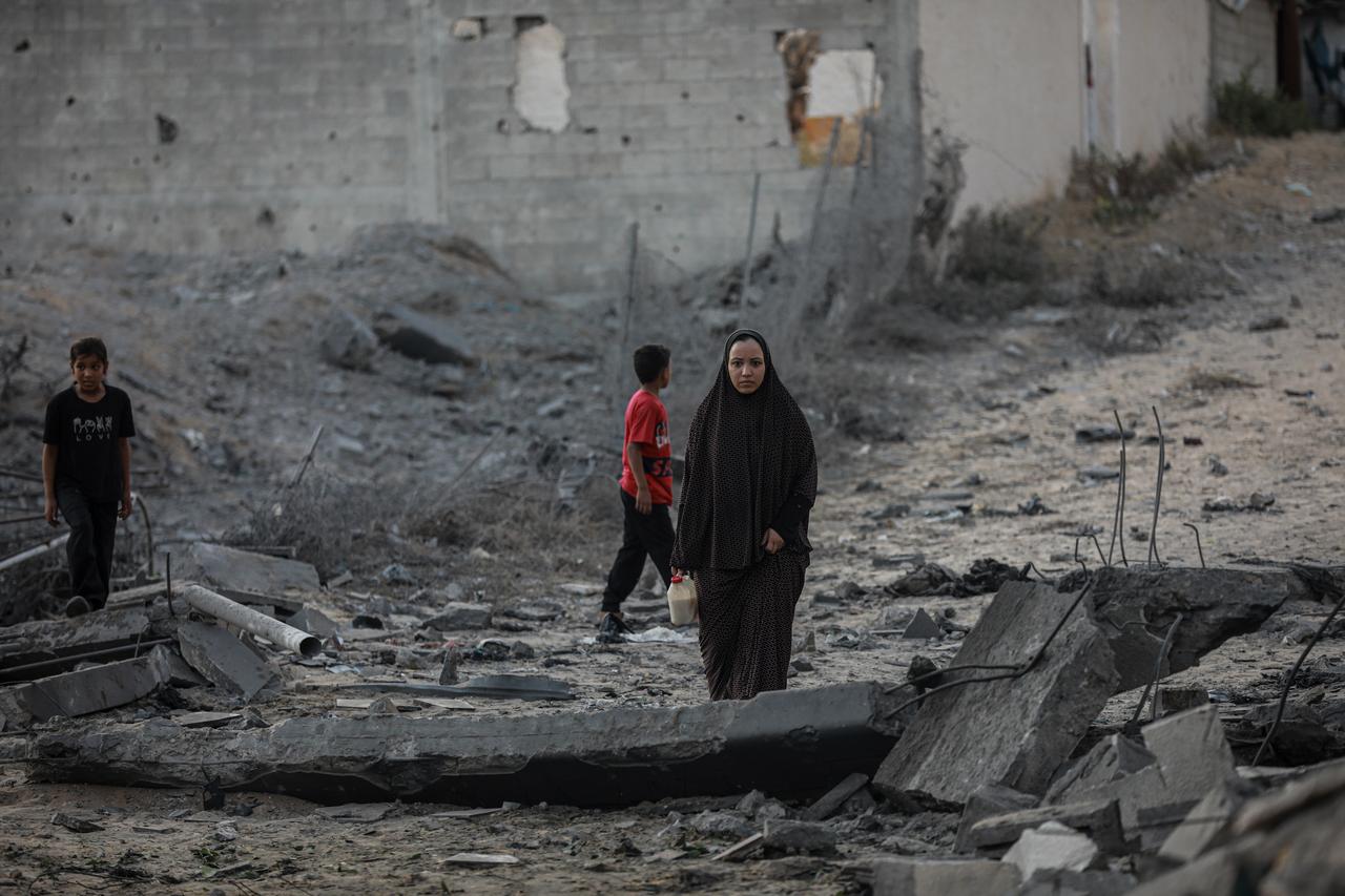 Palestinians search through the rubble of destroyed homes, inspecting the damage and locate survivors after an Israeli airstrike on the Tel al-Hawa neighborhood in the southern Gaza Strip on July 8, 2025. (AA Photo)