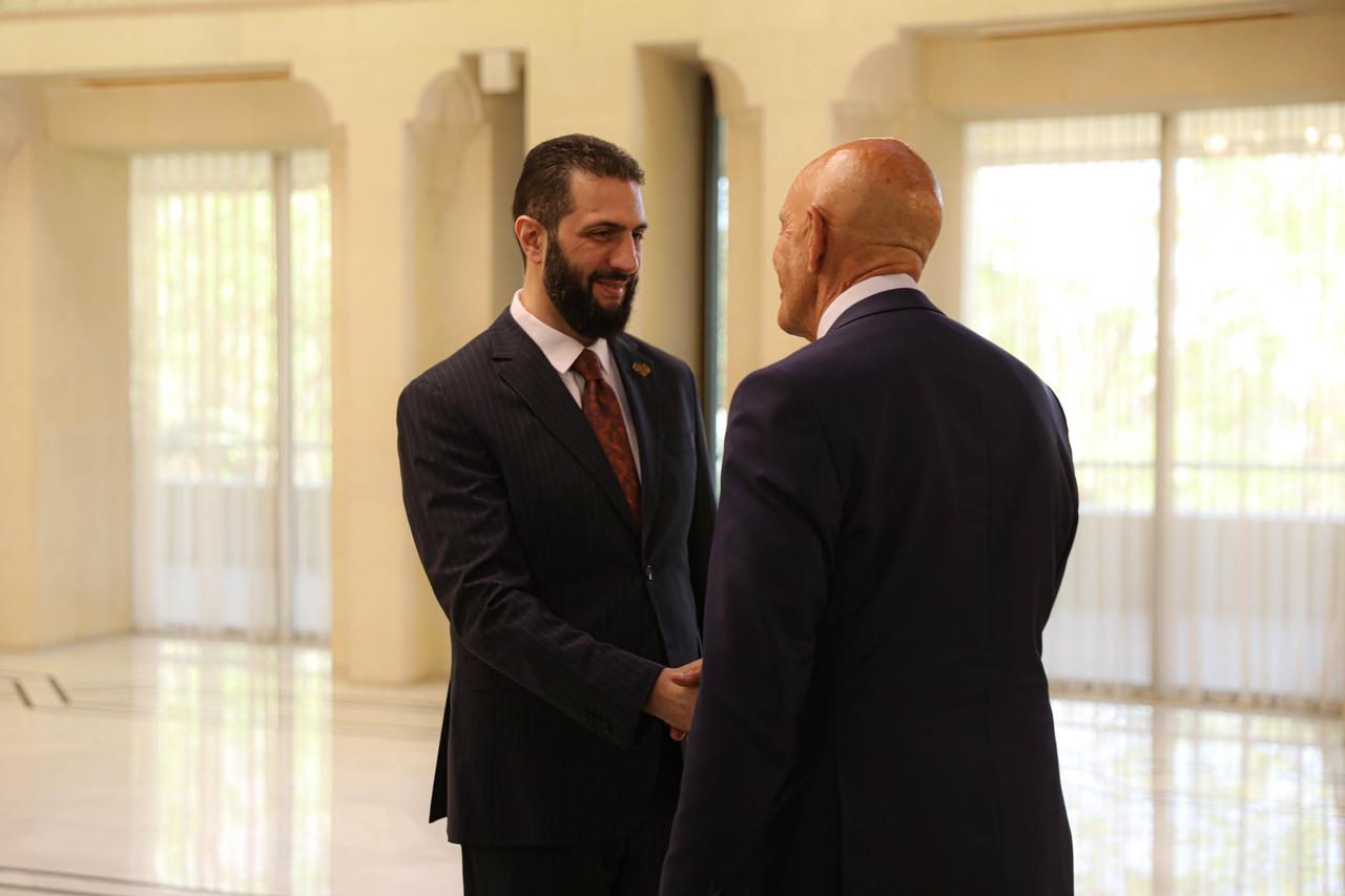 Syrian President Ahmed al-Sharaa (L) welcomes US Ambassador to Ankara and Special Envoy for Syria Tom Barrack (R) and his accompanying delegation at the People's Palace in Damascus, Syria on July 9, 2025.(Photo by AA)