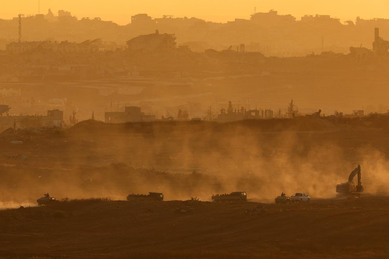 This picture taken from a position at Israel's border with the Gaza Strip shows Israelis army vehicles driving in the besieged Palestinian territory on July 8, 2025. (AFP Photo)