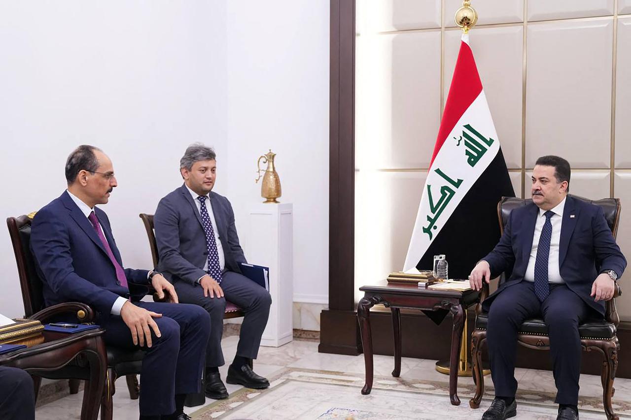 A handout picture released by Iraq's Prime Minister's Media Office shows Iraqi Prime Minister Mohammed Shia al-Sudani (R) during a meeting with Türkiye's intelligence chief Ibrahim Kalin (L) in Baghdad on July 8, 2025. (Photo by Iraq's Prime Minister's Media Office / AFP)