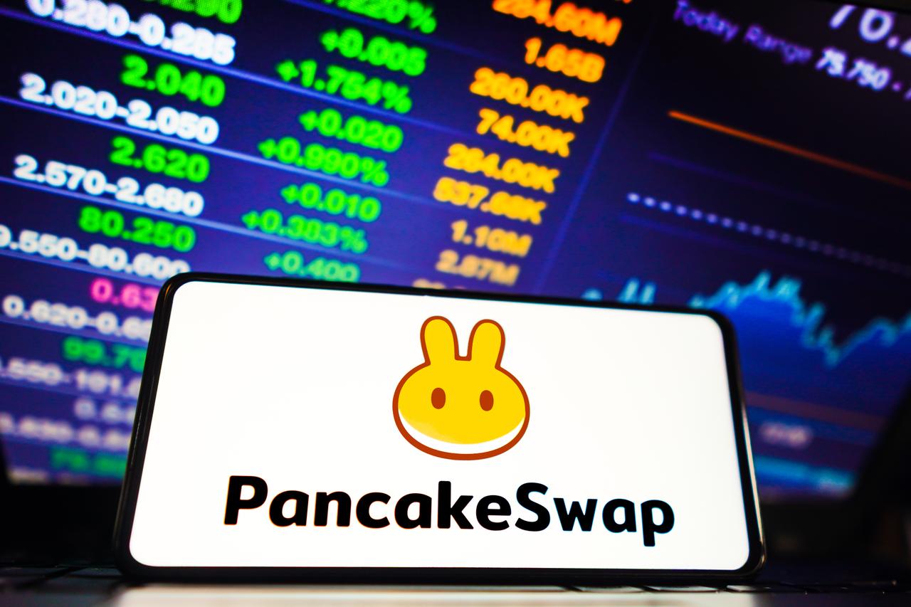 PancakeSwap logo displayed on a smartphone screen, with live market data and trading charts in the background, accessed July 9, 2025. (Adobe Stock Photo)