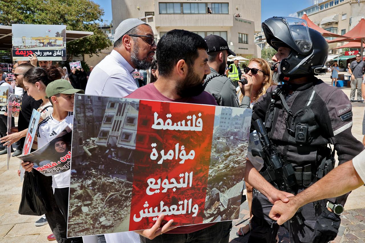 A man argues with an Israeli police officer during a protest by Arab Israelis near the Egyptian embassy in Tel Aviv, July 31, 2025. (Photo by AFP)