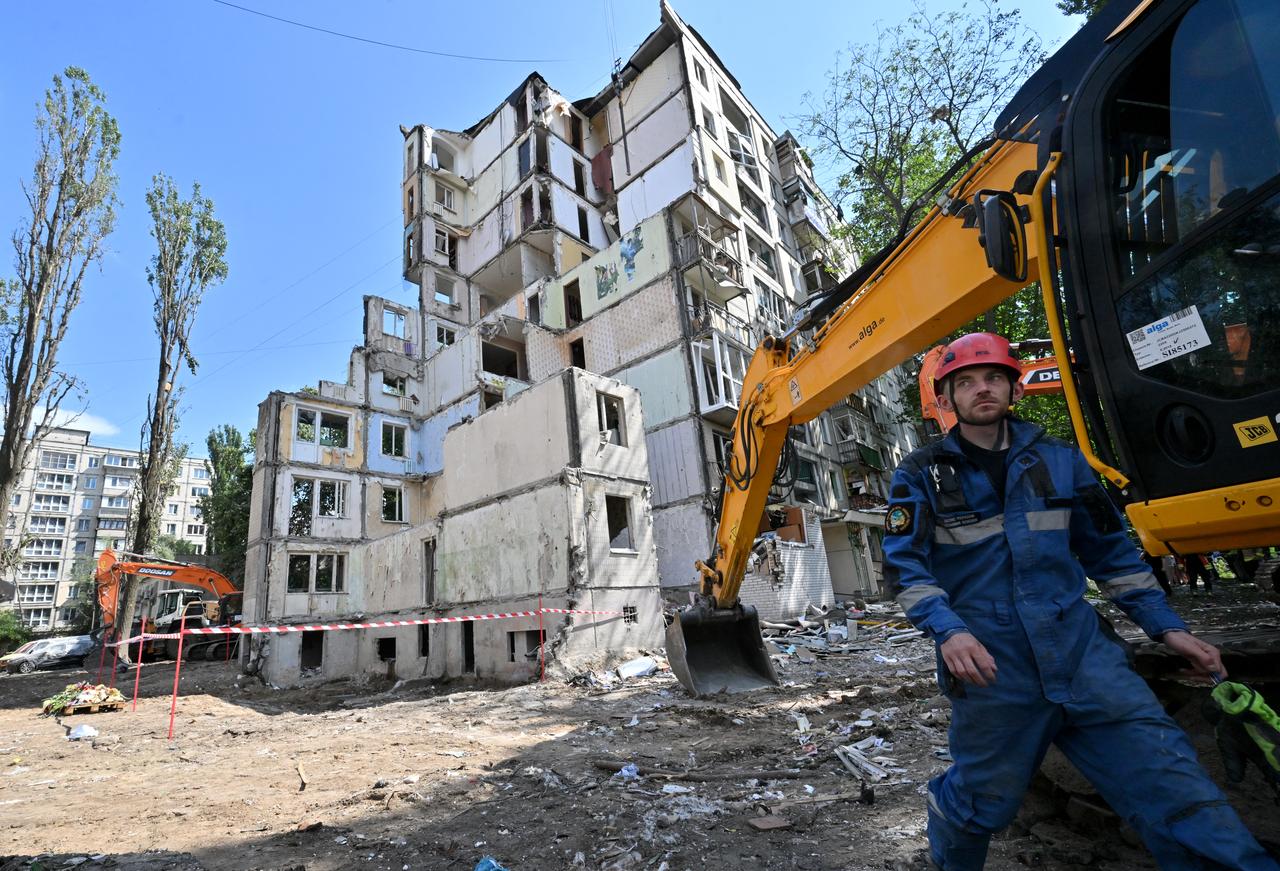 Rescuers walk outside a residential building in Kyiv on August 1, 2025. (AFP Photo)