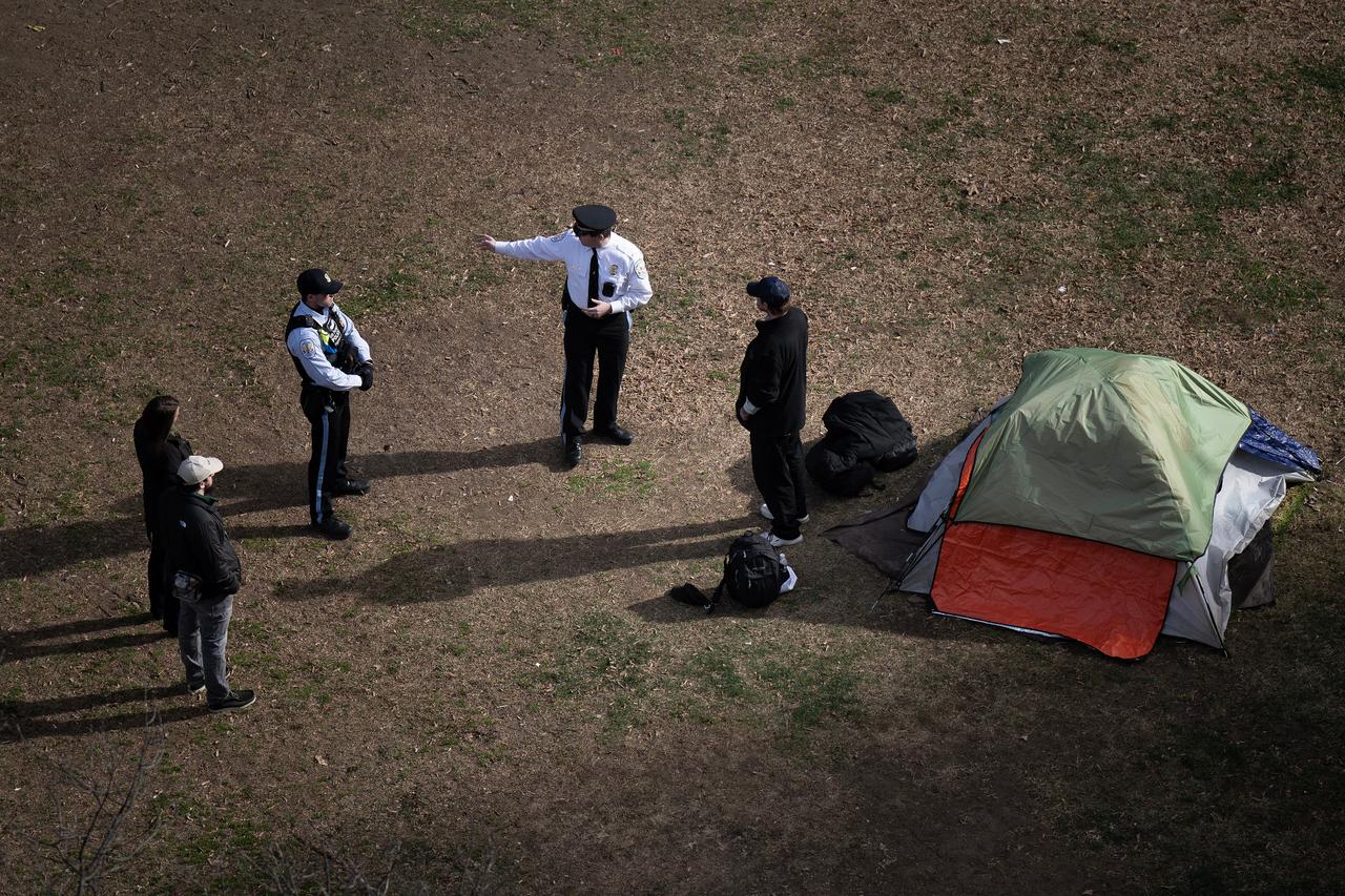 Park Police talk to a man who refused to leave after members of the U.S. National Park Service cleared a homeless encampment from McPherson Square, two blocks from the White House in Washington, U.S. on February 15, 2023. (AFP Photo)