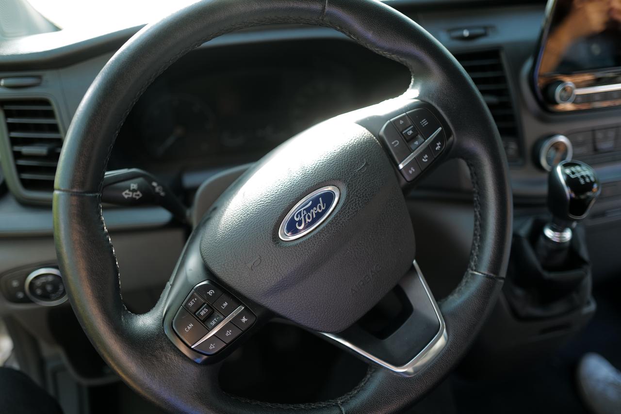 Close-up view of the steering wheel and dashboard design of a Ford Transit. (Adobe Stock Photo)