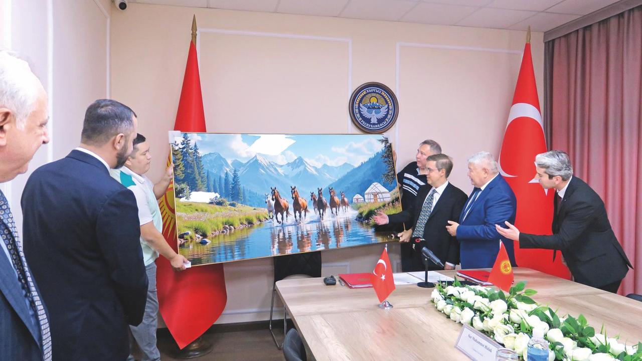 Photo shows Ihlas Holding Chairman Ahmet Mucahid Oren (L) and Kyrgyz Minister of Energy Taalaybek Ibrayev (R) signing $10B energy deal. (IHA Photo)