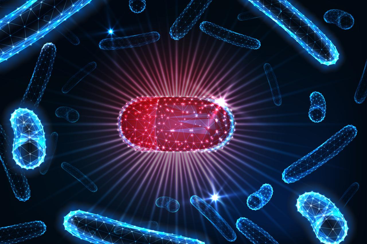 Antibiotic pills placed in a bacterial culture medium, symbolizing the ongoing battle between antibiotics and bacteria in the fight against infections. (Adobe Stock Photo)