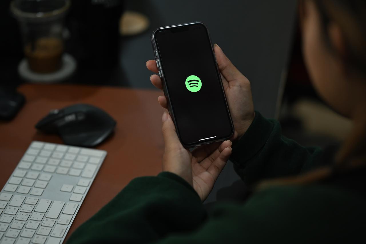 A person holding smart phone with Spotify on screen in Chiang Mai, Thailand on Oct 05, 2022. (Adobe Stock Photo)